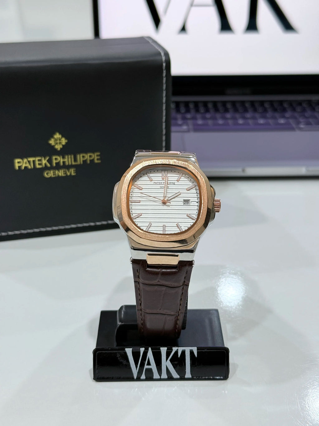 Patek Philippe watch on a stand with a Patek Philippe box in the background