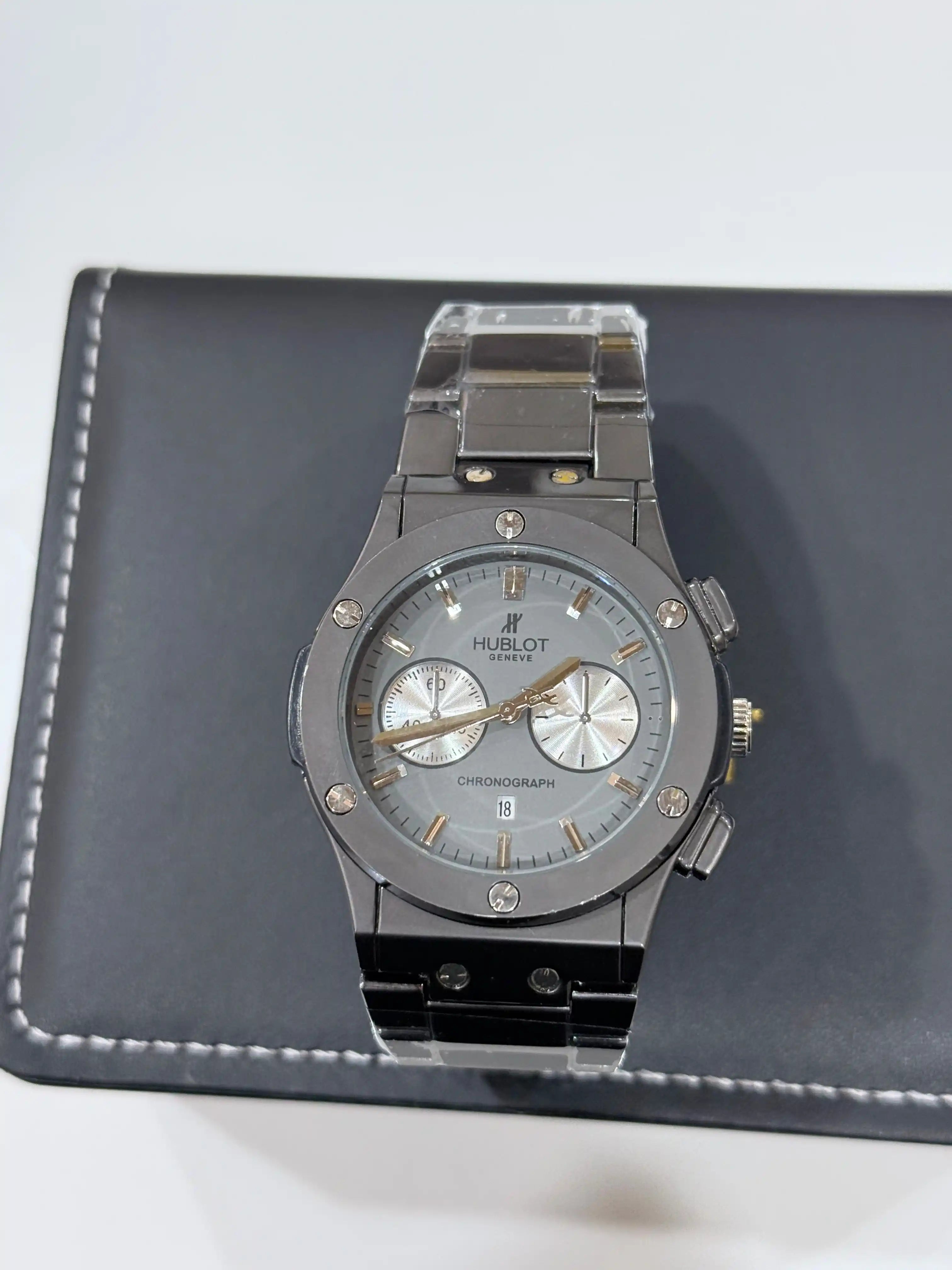 Silver watch with detailed face on a black leather case