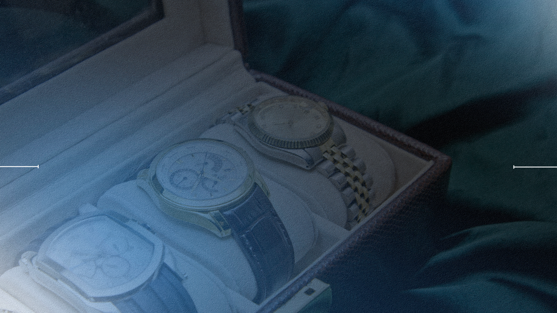 Three watches in a box with a blurred background